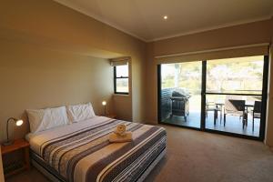 a bedroom with a bed with a teddy bear sitting on it at Saltwater Apartments in Eden