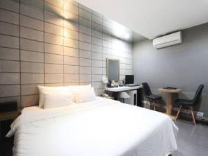 Postel nebo postele na pokoji v ubytování Hotel JUNE Haeundae