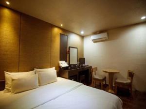 Postel nebo postele na pokoji v ubytování Hotel JUNE Haeundae
