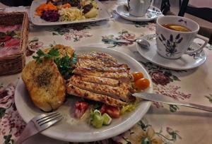 a table with a plate of food and a cup of coffee at Agroturystyka Żabi Raj Serock - Pułtusk in Pokrzywnica