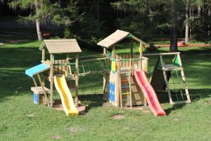 a group of playground equipment in the grass at Bungalovy pri Hoteli Spojar in Žiar