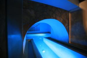 a blue tunnel with a pool of water at Medusa Rooms & SPA in Syracuse