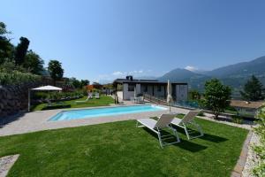 a villa with a swimming pool and two chairs at Moar Lodge in Postal