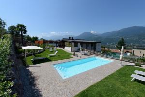 a villa with a swimming pool and mountains in the background at Moar Lodge in Postal