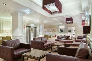 a living room filled with couches and chairs at Edinburgh Grosvenor Hotel in Edinburgh