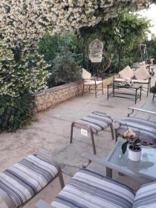a group of picnic tables and chairs on a patio at Apartment Hela in Zadar