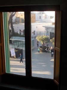 a window with a view of a city street at Casa Montagnese in Anacapri