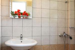 a bathroom with a sink and a mirror and a window at Eleana Studios in Lefkada