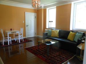 a living room with a couch and a table at Apartment Obelix in Holtorf