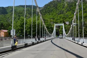 a bridge with a van driving on the road at Kiki's House in Borjomi