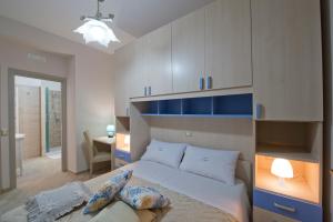 a bedroom with a bed with blue and white cabinets at L'Incanto dei Monti in Agerola