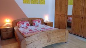 a bedroom with a wooden bed with two lamps at Mayr-Eichberg, Familie Berndl in Wolfsbach