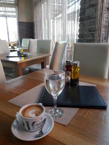 a cup of coffee and a glass of water on a table at Apartmani Nikolina Seaview in Šibenik