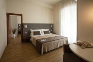 Postel nebo postele na pokoji v ubytování Hotel Miramare