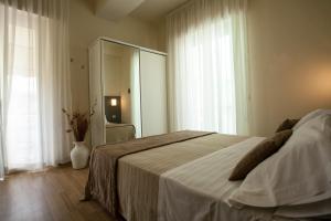 Postel nebo postele na pokoji v ubytování Hotel Miramare