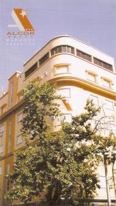 um edifício com uma árvore em frente em Alcor Hotel em Mendoza