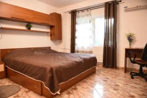 - une chambre avec un lit, un bureau et une fenêtre dans l'établissement Chic Apartment Near City Center, à Cluj-Napoca