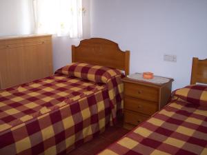a bedroom with two beds and a dresser at Casa Tere in Miller