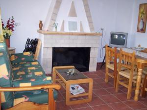 a living room with a fireplace and a table and chairs at Casa Tere in Miller