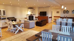 a kitchen and living room with a table and chairs at Saaristohotelli Vaihela in Velkua