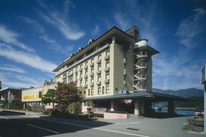 a large building on the side of a street at Fuji Lake Hotel in Fujikawaguchiko