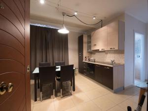 a kitchen and dining room with a table and chairs at Castiglione Residence in Foggia