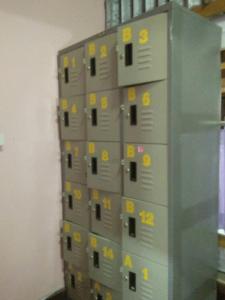 a bunch of boxes in a wall with yellow stickers at Lucky Homestay in Haad Rin +31 photos