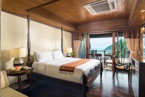 a bedroom with a large bed and a balcony at Panviman Resort Koh Phangan - SHA Extra Plus in Thong Nai Pan Noi +37 photos
