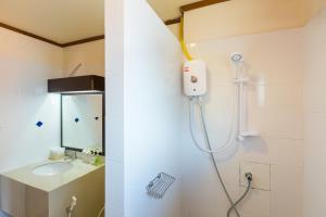 a bathroom with a shower and a sink at Sunrise Resort- Koh Phangan - SHA Extra Plus in Haad Rin