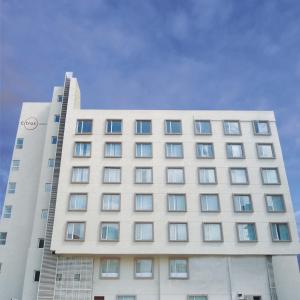 a large white building with windows on it at Citrus Classic Bengaluru in Bangalore