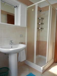 a bathroom with a sink and a shower at Castello 9 in Isola del Giglio +25 photos