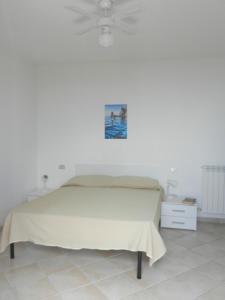 a bedroom with a bed and a ceiling fan at Castello 9 in Isola del Giglio