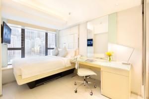 a bedroom with a desk and a bed and a desk and chair at iclub Sheung Wan Hotel in Hong Kong