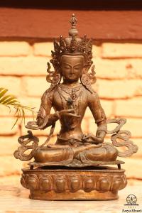 a statue of a deity sitting on a table at Aarya Chaitya Inn in Kathmandu