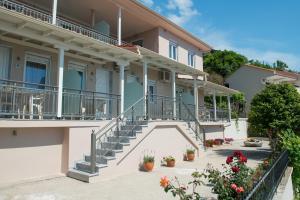 a building with stairs and potted plants at Villa Roula in Koinyra
