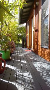a walkway outside of a house with plants at Cosy Romantic Cottage in Tallebudgera
