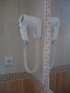 two hair dryers are attached to the wall of a bathroom at Parkhotel Terezín in Terezín