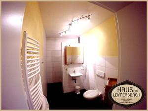 a small bathroom with a toilet and a sink at Haus am Leimersbach in Hattenheim