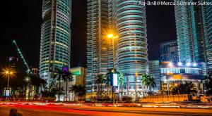 a city skyline with tall buildings at night at Resort Hostel In City in Kuala Lumpur