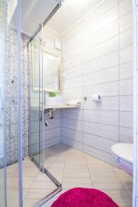 a bathroom with a glass shower and a sink at Apartments Laura in Korčula
