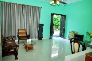 a living room with chairs and a glass table at Vimean Sovannaphoum Resort in Battambang