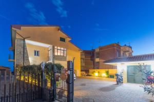 a house with a gate in front of it at B&B Livia in Castiglione della Pescaia