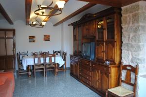 a dining room with a table and a tv in a room at Abuelo Duplex in Mora de Rubielos