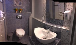 a small bathroom with a sink and a toilet at Palmyra Studios in Stavros +32 photos