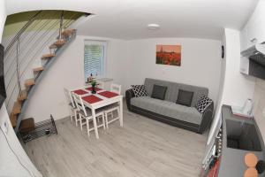 a living room with a table and a couch at Apartment April in Bled
