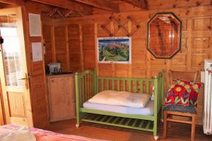 mały pokój z łóżkiem w drewnianym domku w obiekcie B&B Casa Delle Fate w mieście Campodenno