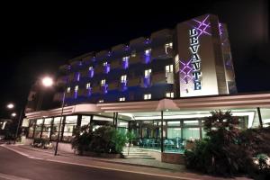 a building with a lit up sign in the night at Hotel Levante in Bellaria-Igea Marina