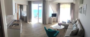 a living room with a couch and a table at Helios Hotel in Balchik
