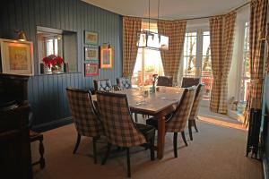 a dining room with a table and chairs at The Jug And Bottle in Heswall