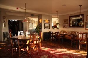 a dining room with a table and chairs at The Jug And Bottle in Heswall